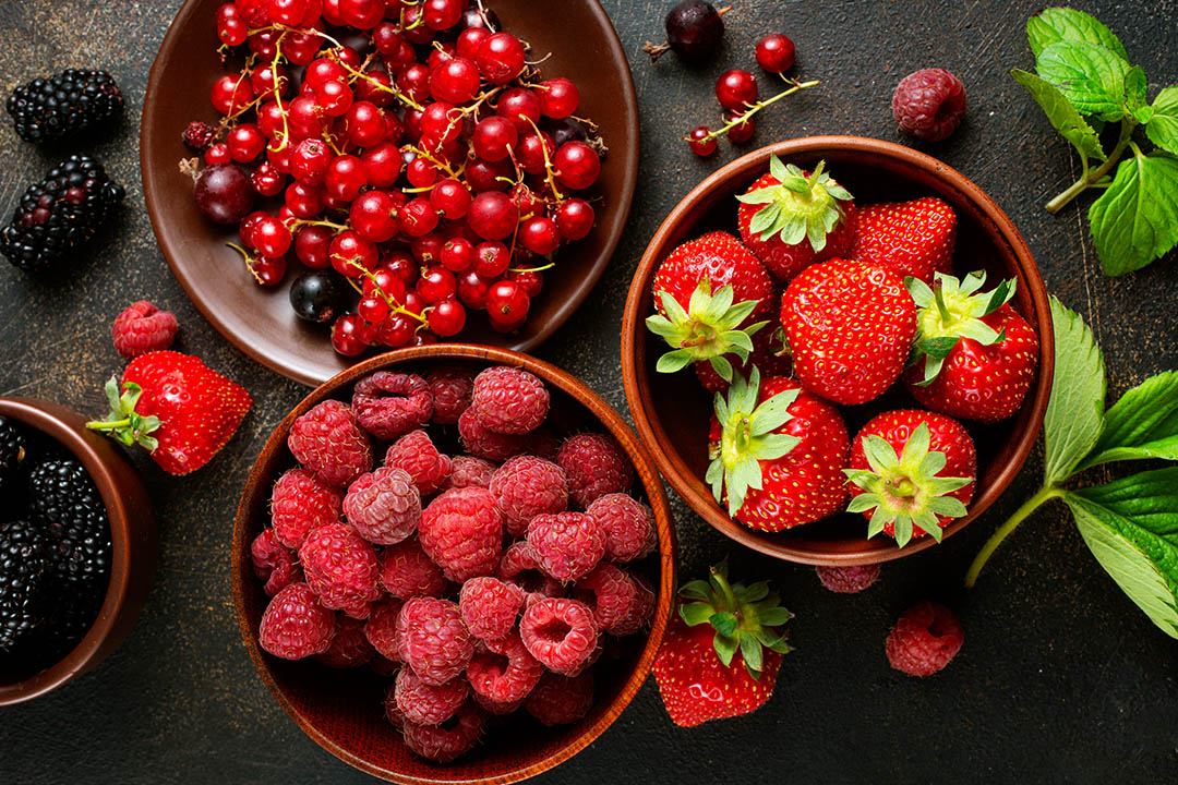 Picture of various berries in bowls on table